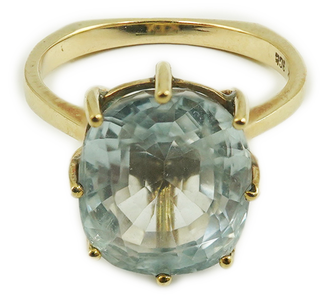 A 1970's 9ct gold and single stone oval cut aquamarine set dress ring